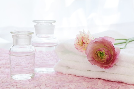 Bottles, towel and ranunchulusの写真素材