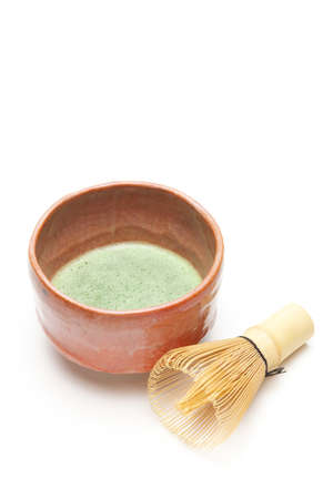 Japanese matcha tea in a bowl and tea whisk on white backgroundの写真素材