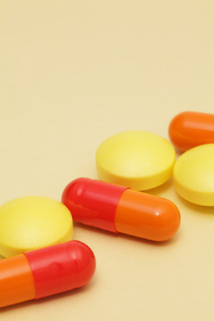 Colorful pills on yellow backgroundの写真素材