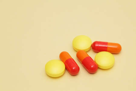 Colorful pills on yellow backgroundの写真素材