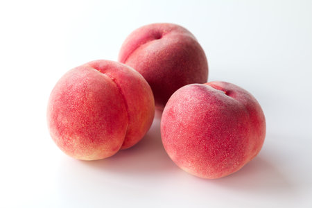 Ripe Japanese peaches on white backgroundの写真素材
