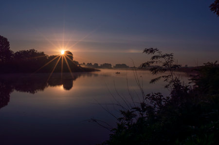 Sunrise on the river in a misty morning. Landscape.の写真素材