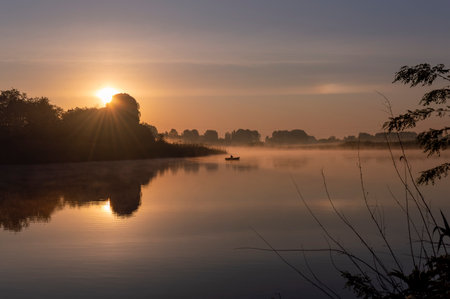Sunrise over the river in the morning mist. Landscape.の写真素材