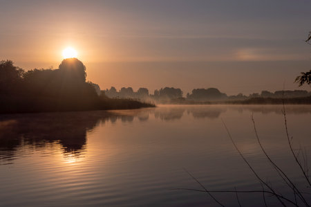 Sunrise over the river in the morning mist. Beautiful landscape.の写真素材