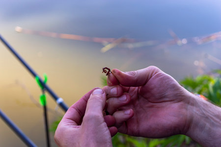 Fisherman holding a fishing rod in his hand. Close-up.の写真素材
