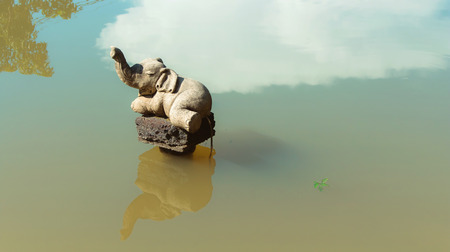 stucco elephant in waterの写真素材