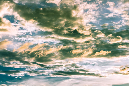 Yellow Cloud streaks and green color in blue sky