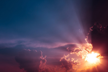 Beam light from the bright sun and many colorful sky with cloudsの写真素材