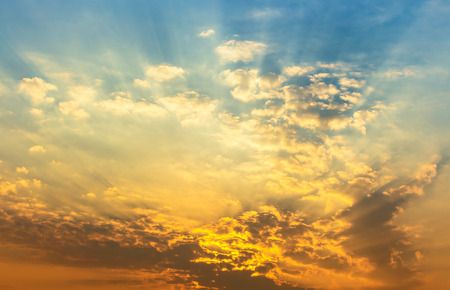Orange and yellow sunset light with clouds
