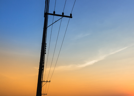 electric pole  with orange and blue skyの写真素材