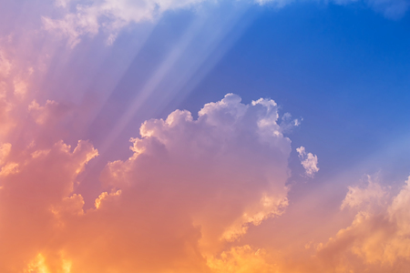 Pink and orange light in blue sky with sun ray