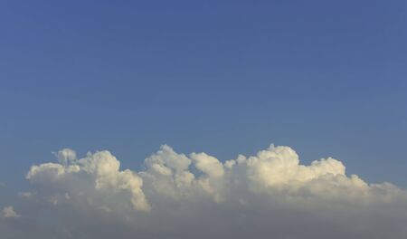 dim blue sky with fluffy clouds and day light