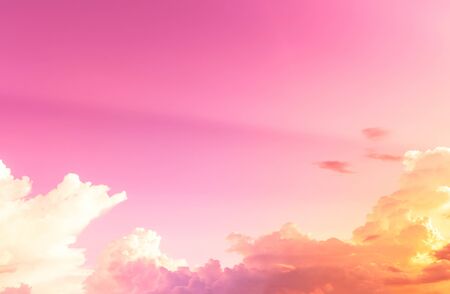 orange light in soft white clouds with pink skyの写真素材
