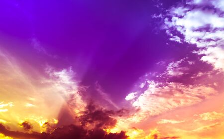 many color sunset light in overcast sky with clouds
