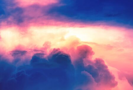 orange color light with pink neon light in overcast sky with deep blue cloudsの写真素材