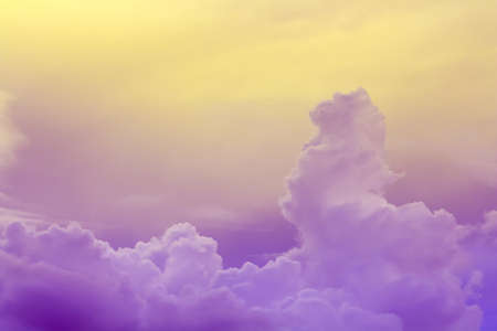 purple blue clouds in yellow skyの写真素材