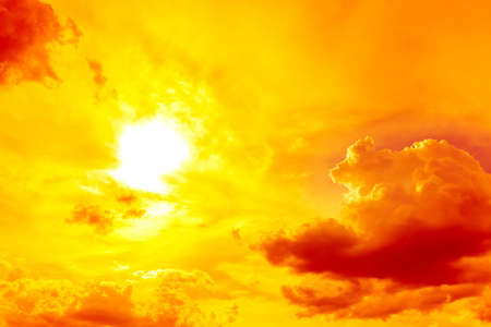 bright hot sun on orange sky with red lightの写真素材