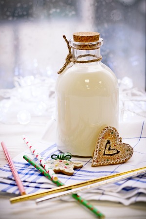 New Years still life with a bottle of milk, biscuitsの写真素材