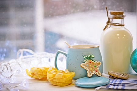 Christmas still-life with an open sugar bowl, white spoon, cookies, pasta, Christmas-tree blue ball,...