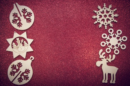 Christmas wooden figures on red brilliant backgroundの写真素材