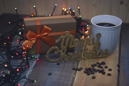 Brown gift box, inscription Marry Christmas blue cup of coffeeの写真素材