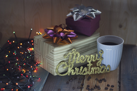 Two gift boxes, inscription Marry Christmas, a cup of coffeeの写真素材