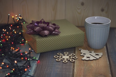 Gift box, a Christmas tree and a snowflake, cup on the tableの写真素材