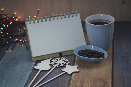 Blue cup and notebook on Christmas tableの写真素材