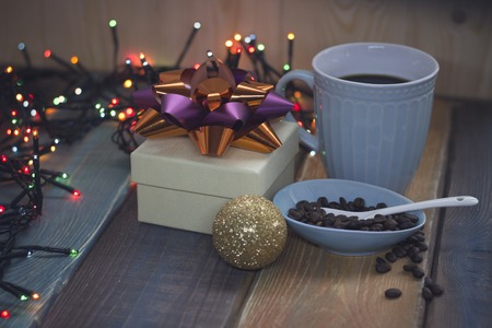 White gift box, blue cup, coffee beans in a bowl,  golden ballの写真素材