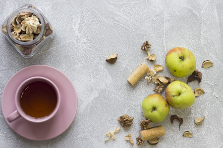 Still life with a pink tea cup, glass jar, dry flowers and green applesの写真素材