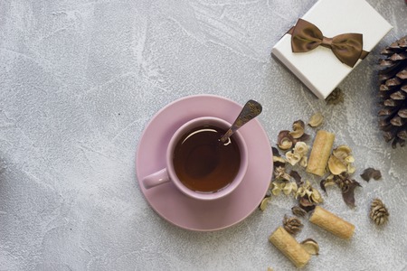 Cristmas still life with a cup, spoon, giftbox and a pineconeの写真素材
