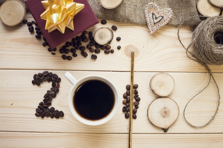 2018 inscription of coffee beans, coffe mug and wooden slicesの写真素材