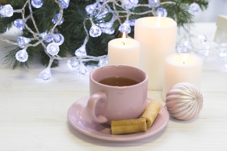 A festive still life with tea and candles in white and pink colorsの写真素材