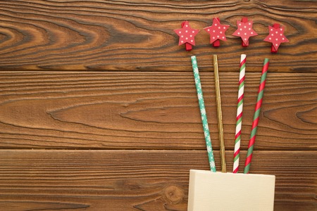 Christmas background with a box, straws and star clipsの写真素材