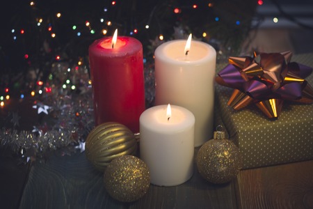 Still life with burning candles, Christmas tree balls and a gift boxの写真素材