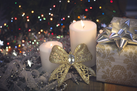 Still life with burning candles, Christmas decorations and a gift box