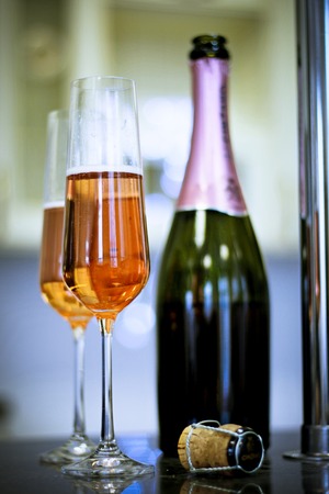 Two filled glasses and a bottleの写真素材