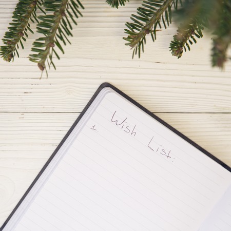 Christmas light wooden background with inscriptionの写真素材