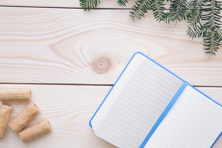 Christmas light wooden background with a notebookの写真素材