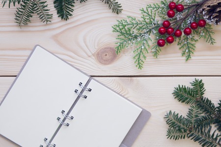 Christmas light wooden background with a notebookの写真素材