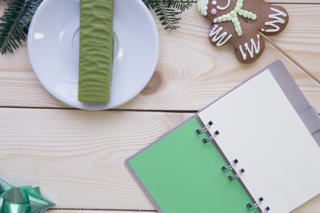 Christmas light wooden background with a notebookの写真素材