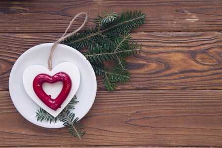 Christmas rustic wooden background with fir tree branches and decorationsの写真素材