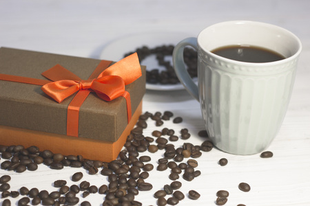 Cup of coffee and a gift boxの写真素材