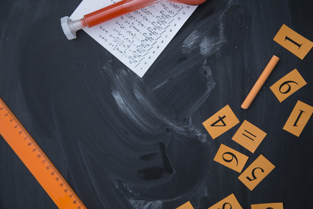 School background with a frame of numbers,a ruler, paper with math exercises and a beaker. Space for...
