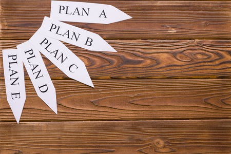 Business and work concept wooden background with paper arrows in a shape of sun.の写真素材