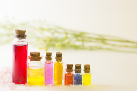 Spa essentials set- aroma oils with natural herbs and fruit extracts in tiny glass jars with corks,...