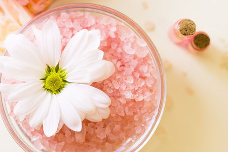 Massage and aromatherapy items set. A glass bowl with bath salth, glass jars with corks with essential oil, close up. Top view. Space for a text or product display.の写真素材