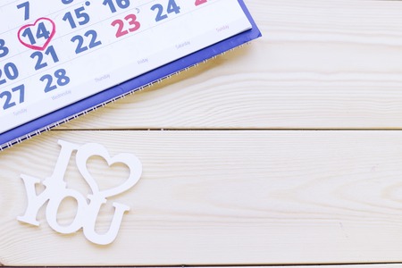 Concept of St.Valentine's Day, anniversary, wedding with a calendar and I Love You inscription wooden background top viewの写真素材