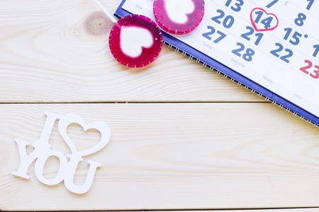 Concept of St.Valentine's Day, anniversary, wedding with a calendar and I Love You inscription wooden background top viewの写真素材