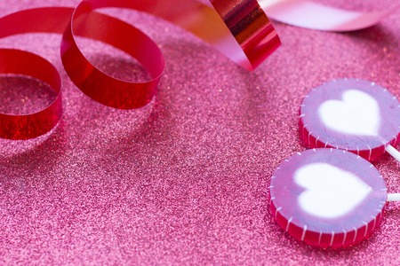 Concept of Valentine's Day with red decorations glitter red background, close upの写真素材